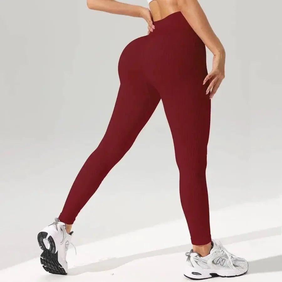 Burgundy high-waisted leggings with ribbed texture, styled with white sneakers for women's fashion