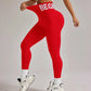 Red high-waist leggings with 'BEGIN' waistband, paired with white sports bra and sneakers for women's fitness fashion