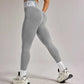 Gray high-waist leggings with 'BEGIN' text, paired with white sports bra and sneakers for fitness fashion