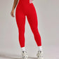Red high-waist leggings with white lettering, paired with white crop top and sneakers for women's fashion