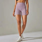 Lavender high-waisted biker shorts for women, stylish athleisure wear with white sneakers