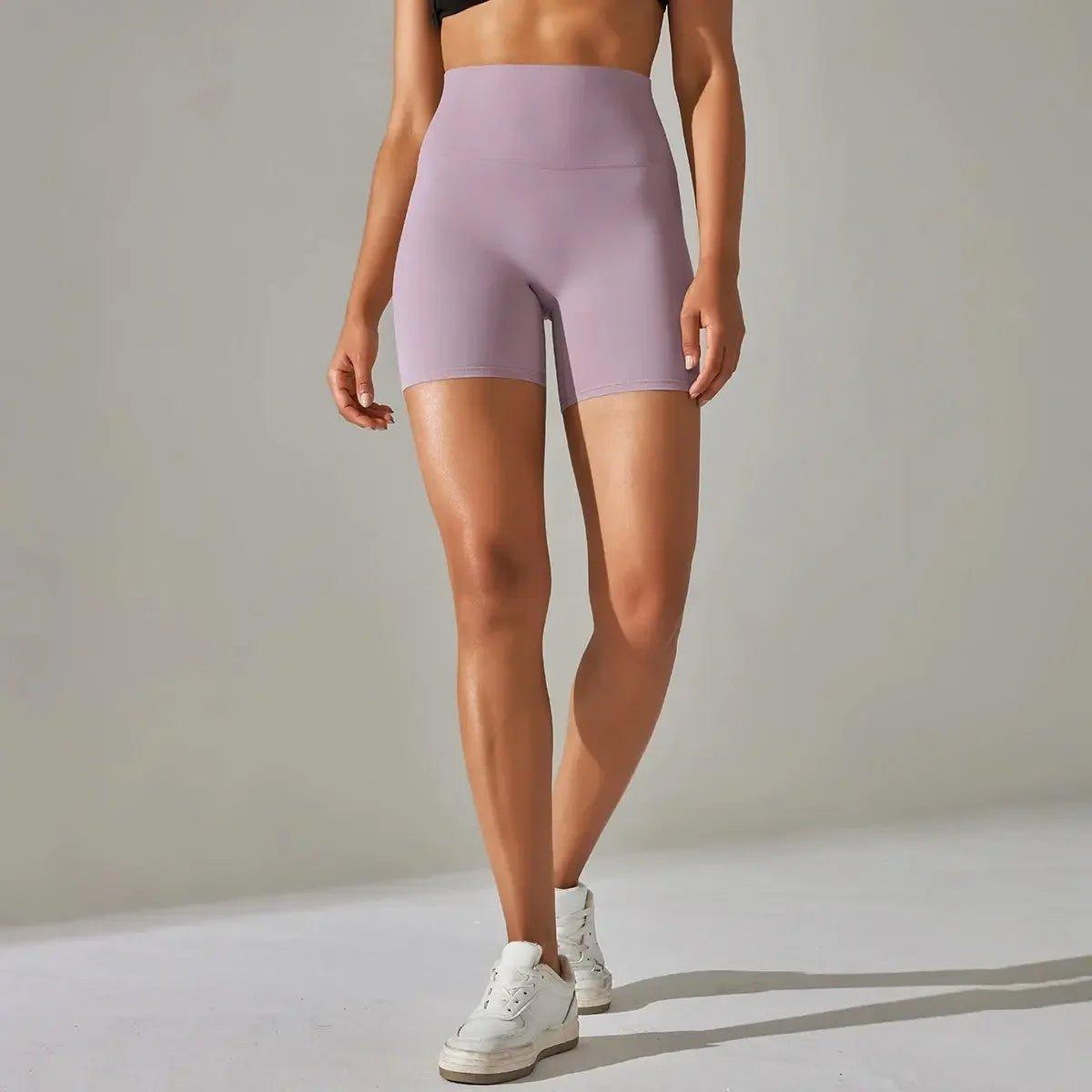 Lavender high-waisted biker shorts for women, stylish athleisure wear with white sneakers
