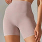 High-waisted women's bike shorts in soft pink, perfect for fashion and fitness