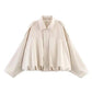 Cream women's oversized blouse with bishop sleeves and ruffled hem, stylish fashion top