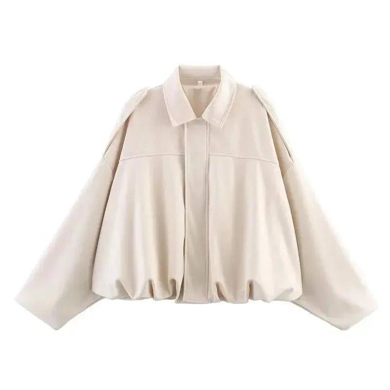 Cream women's oversized blouse with bishop sleeves and ruffled hem, stylish fashion top