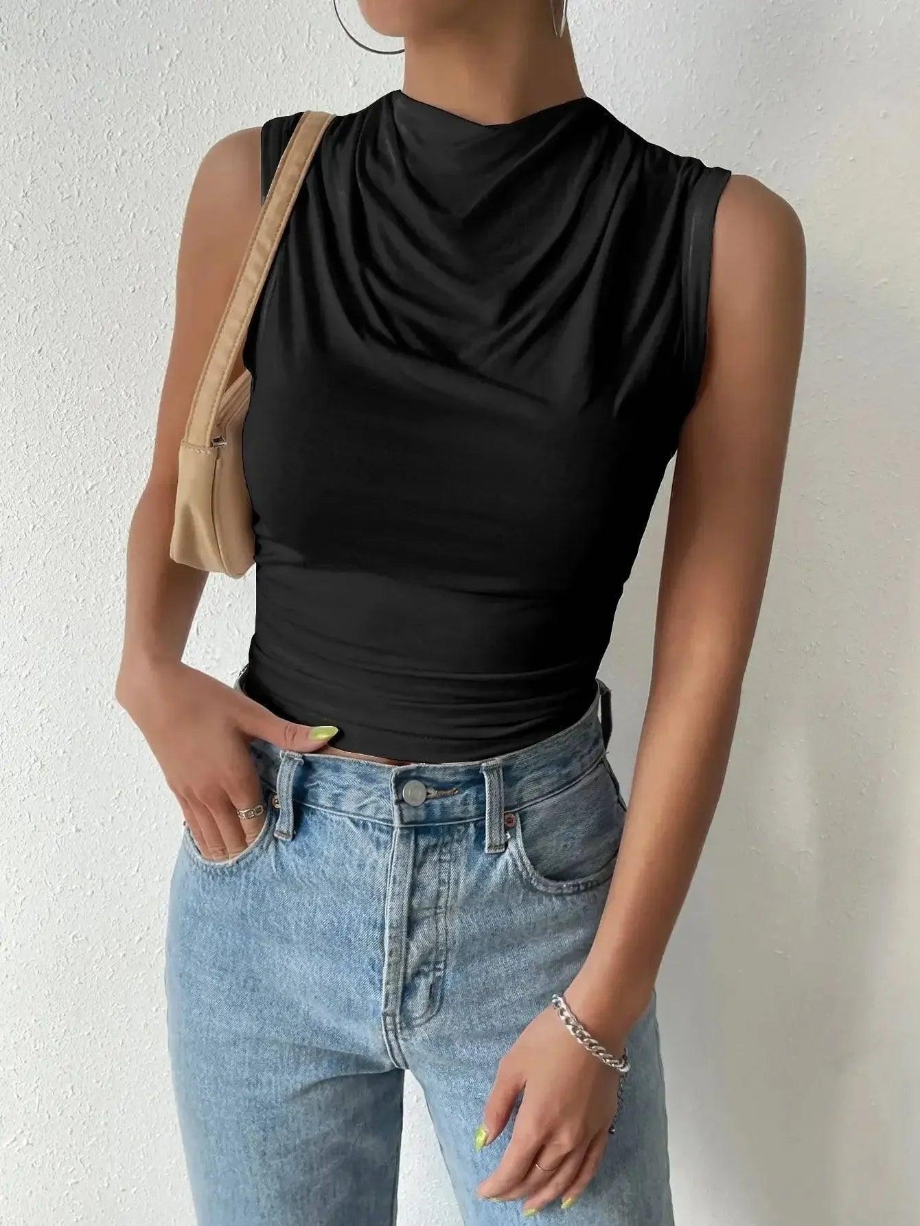 Black sleeveless cowl neck top with high-waisted jeans, women's fashion outfit
