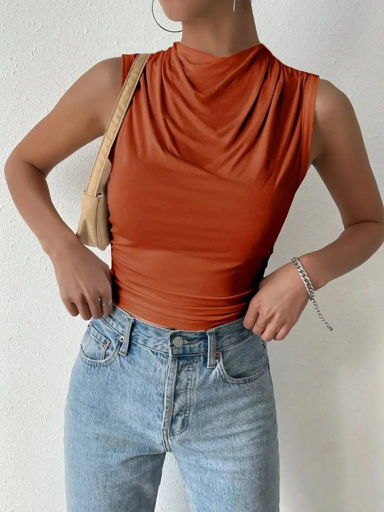 Rust sleeveless cowl neck top with high-waisted jeans, perfect for women's fashion