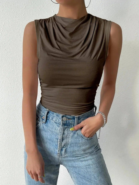 Olive green sleeveless cowl neck top with ruched detail, paired with light wash jeans for women's fashion