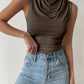 Olive green cowl neck sleeveless top paired with high-waisted light wash jeans for women's fashion
