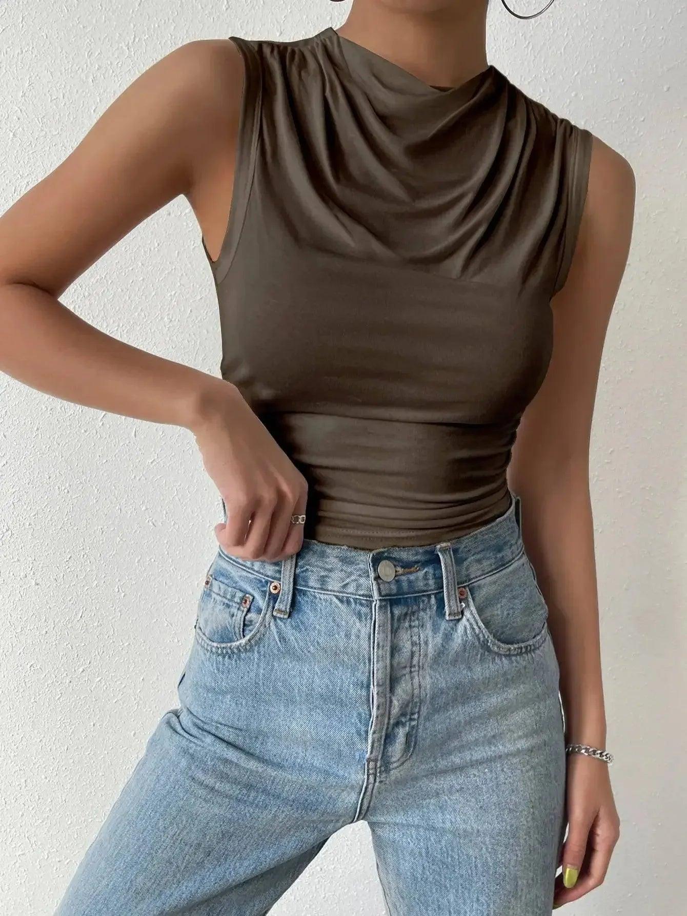 Olive green cowl neck sleeveless top paired with high-waisted light wash jeans for women's fashion