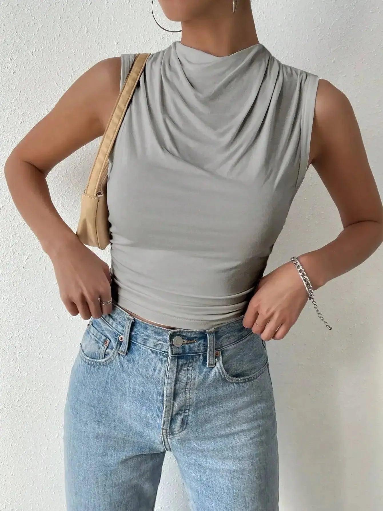 Gray sleeveless cowl neck top with high-waisted jeans, women's fashion outfit