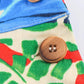 Floral print women's dress with wooden button detail, vibrant green red blue pattern