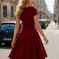 Woman in elegant red A-line dress walking on city street, fashion outfit for daily wear