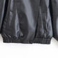 Black faux leather bomber jacket with ribbed hem and front pockets, women's fashion outerwear
