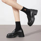 Black platform loafers with chunky heels, styled with black socks for women's fashion