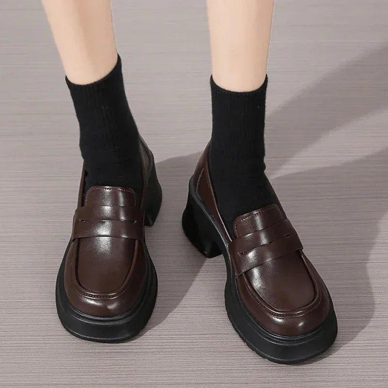 Brown platform loafers with black socks, stylish women's fashion shoes