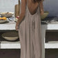 Woman in backless beige maxi dress, summer fashion, outdoor dining setting