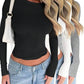 Black long sleeve crop top with ruched detail, styled with jeans and white bag, women's fashion