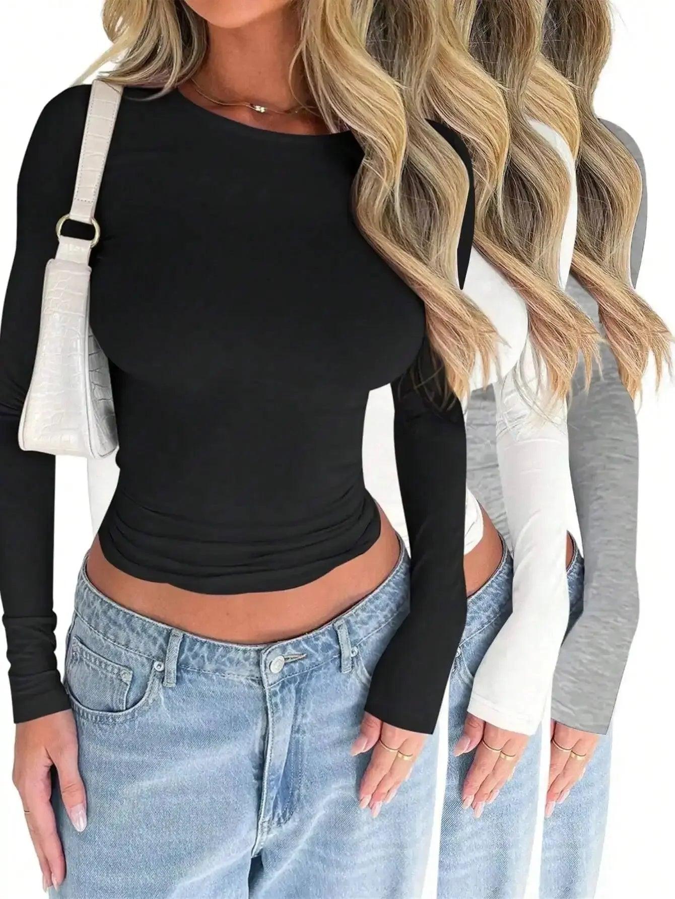 Black long sleeve crop top with ruched detail, styled with jeans and white bag, women's fashion