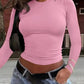 Pink long sleeve crop top for women, stylish streetwear fashion with jeans and belt