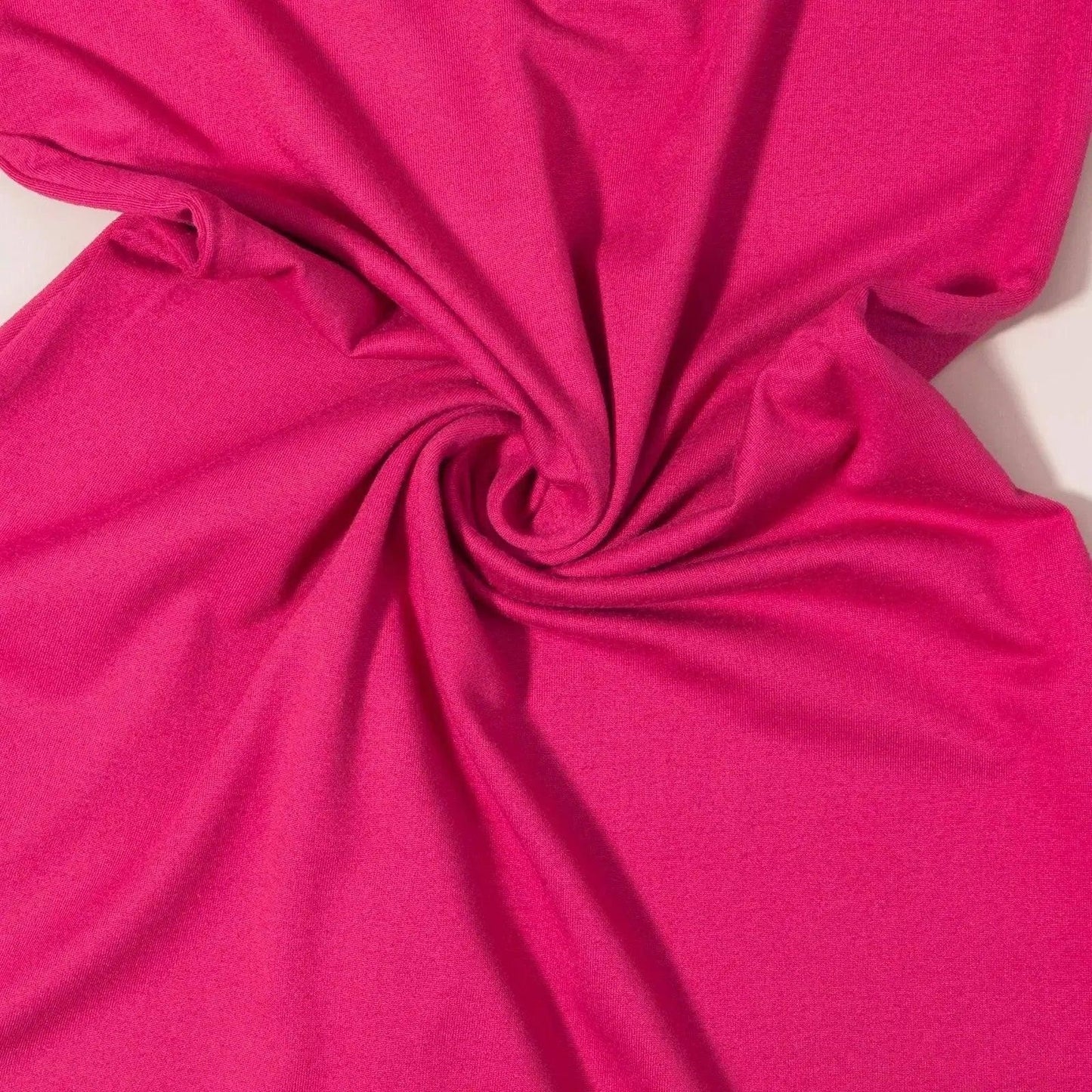 Vibrant pink women's fashion fabric with soft swirl texture, ideal for stylish apparel and trendy outfits