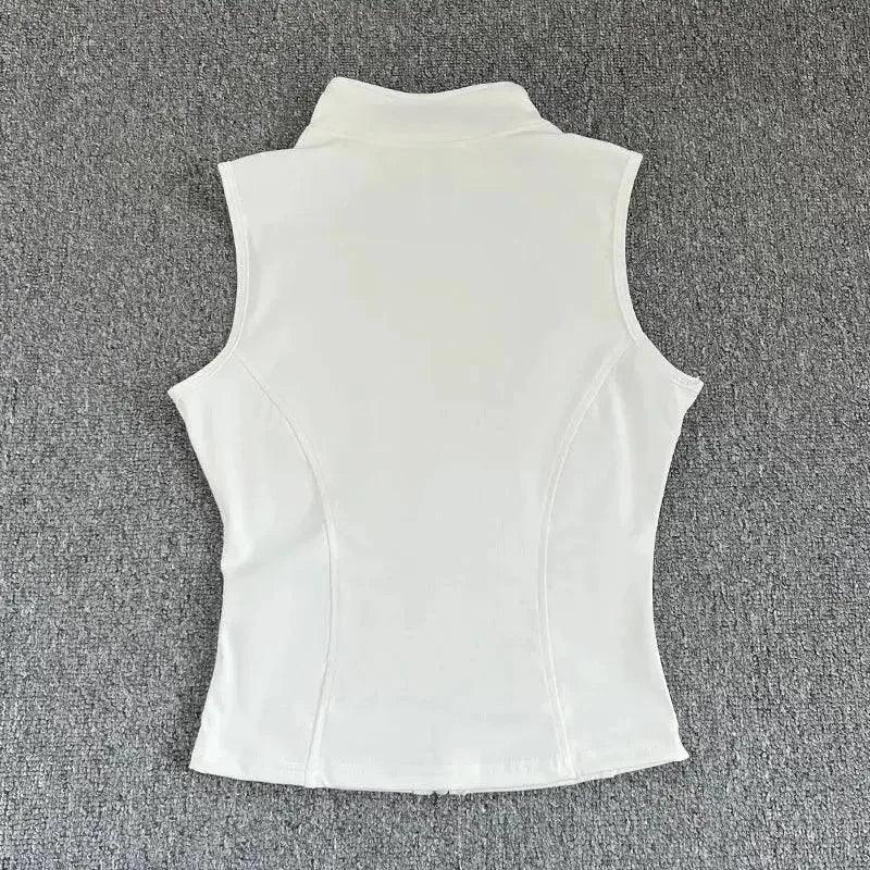 White sleeveless women's top with high neck and fitted back, ideal for fashion and beauty styles