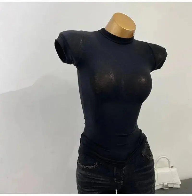 Black sheer mesh top with short sleeves on mannequin, paired with dark jeans for women's fashion