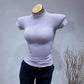 Lavender women's fitted turtleneck top with short sleeves, displayed on mannequin for fashion styling