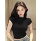 Woman wearing black short sleeve crop top, fashion outfit for casual style