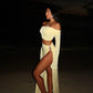 Woman in elegant off-shoulder yellow two-piece dress with high slit, beach night fashion