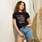 Woman wearing black graphic tee with pink 'Fuck Normal I Want Magic' text, denim shorts, casual fashion
