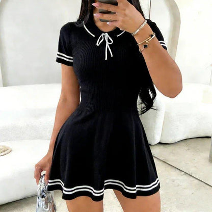 Black ribbed knit dress with white trim, sailor collar, and bow detail — women's fashion