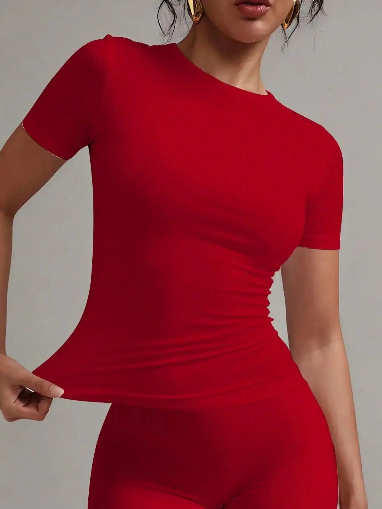 Woman in red fitted short sleeve top and matching pants, stylish fashion outfit