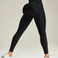 Black high-waist leggings with sculpting fit, paired with white sneakers for women's fashion and fitness