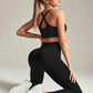 Woman in black crisscross back sports bra and high-waisted leggings with white sneakers, fitness fashion
