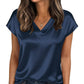 Navy blue satin V-neck women's top with short sleeves, paired with jeans and gold jewelry for casual fashion.