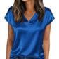 Woman wearing blue satin V-neck top with short sleeves, paired with jeans, for casual fashion