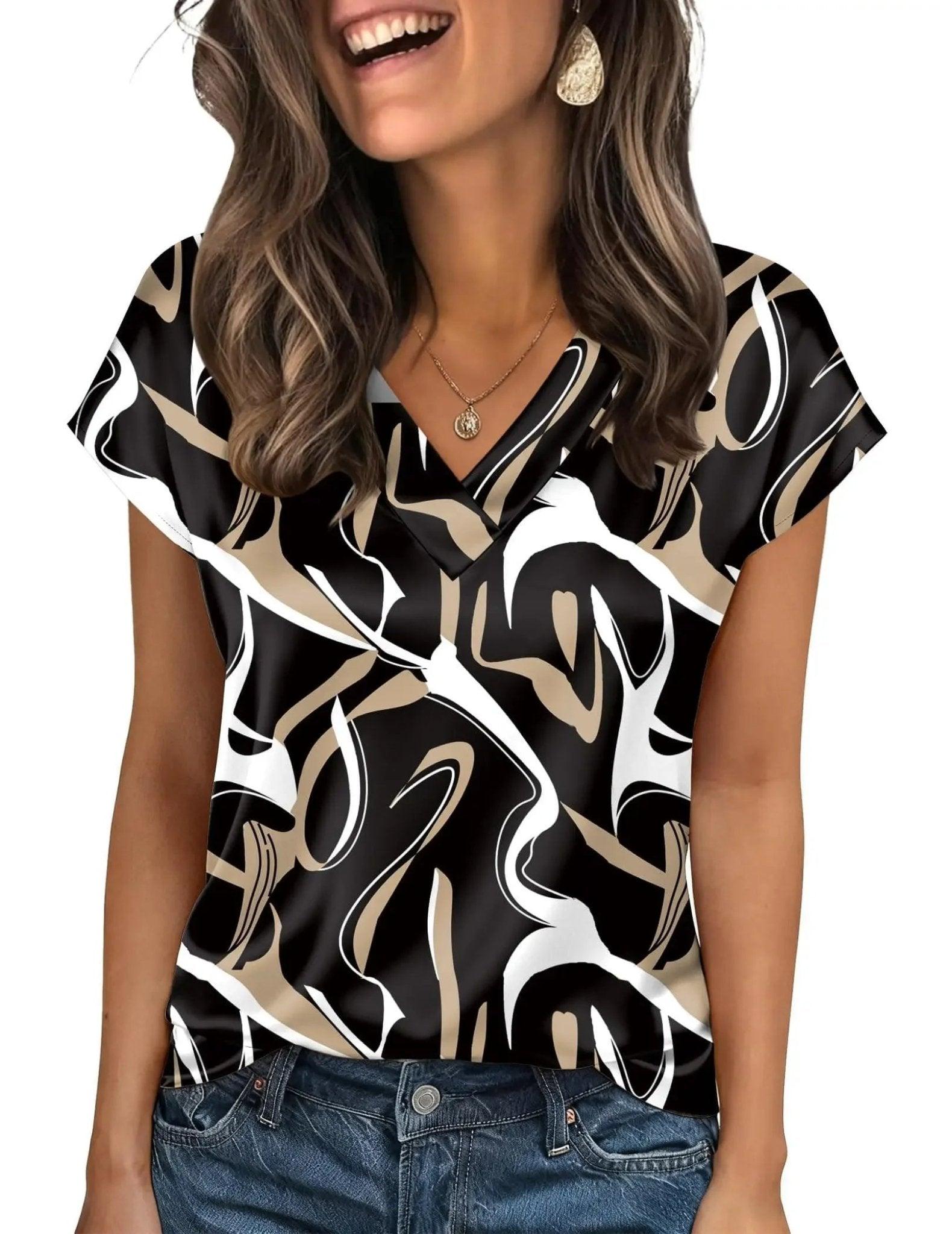 Woman wearing stylish black and white abstract print V-neck blouse with gold jewelry, perfect for casual fashion.