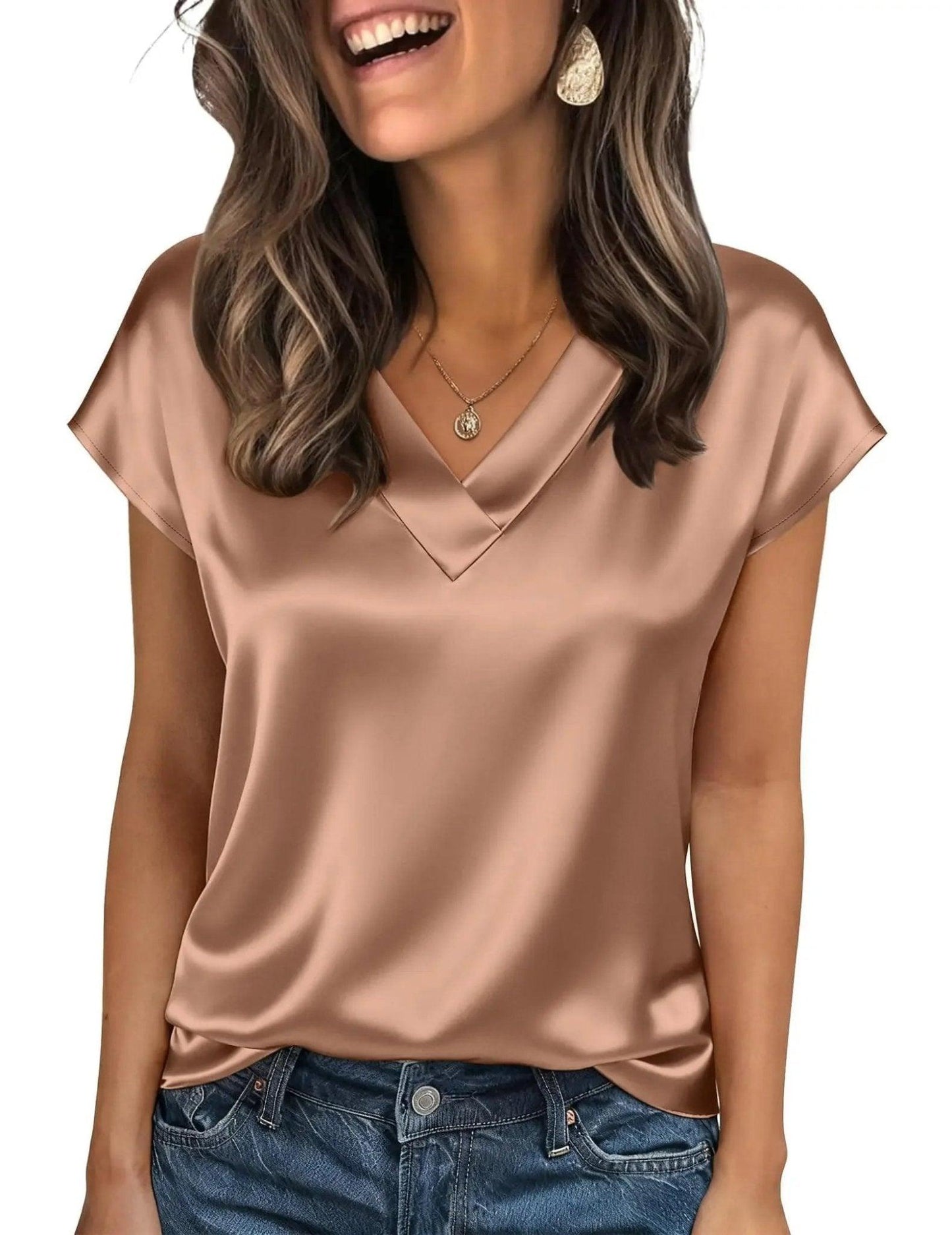 Woman wearing elegant satin V-neck blouse with short sleeves, paired with jeans for casual fashion