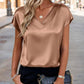Woman in chic satin V-neck top, black pants, and croc-texture chain bag for stylish street fashion