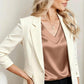 Woman in cream blazer and satin top, stylish office fashion outfit