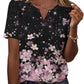 Black floral print women's V-neck tee with pink cherry blossoms and sparkle details, paired with jeans