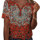 Woman wearing red patterned V-neck short sleeve blouse with buttons, paired with jeans for casual fashion