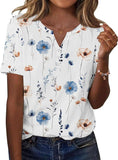Women's floral print V-neck blouse with blue and peach flowers, short sleeves, button front, paired with jeans