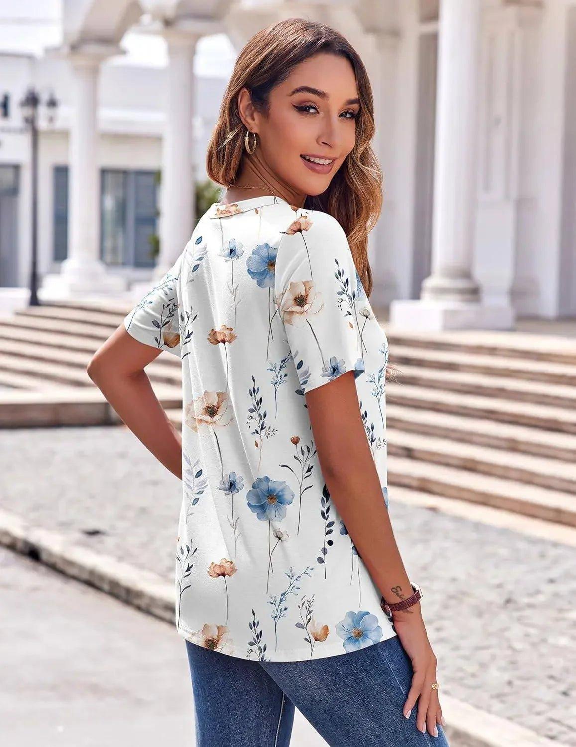 Woman wearing floral print blouse with blue and beige flowers, paired with jeans, outdoors near columns