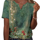 Green floral print women's V-neck blouse with short sleeves and button detail, paired with jeans
