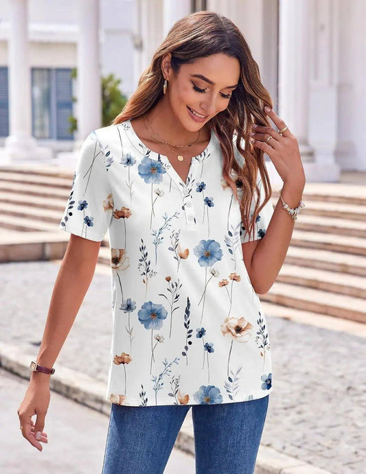 Woman in white floral print V-neck blouse with blue and beige flowers, paired with jeans, outdoor fashion