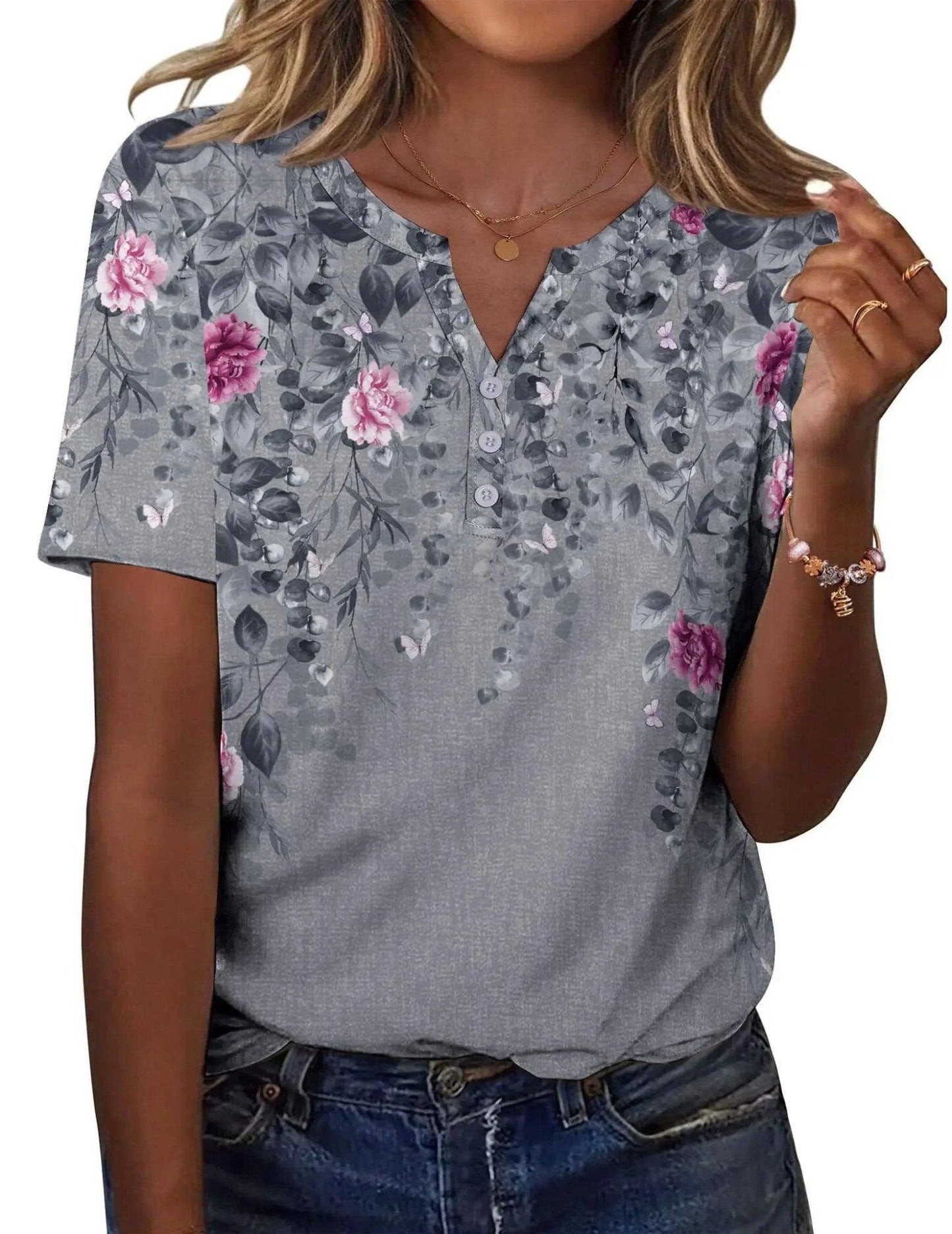 Women's gray floral print V-neck short sleeve top with button detail, paired with jeans