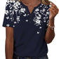 Navy blue floral print women's V-neck button-up top with short sleeves, paired with jeans