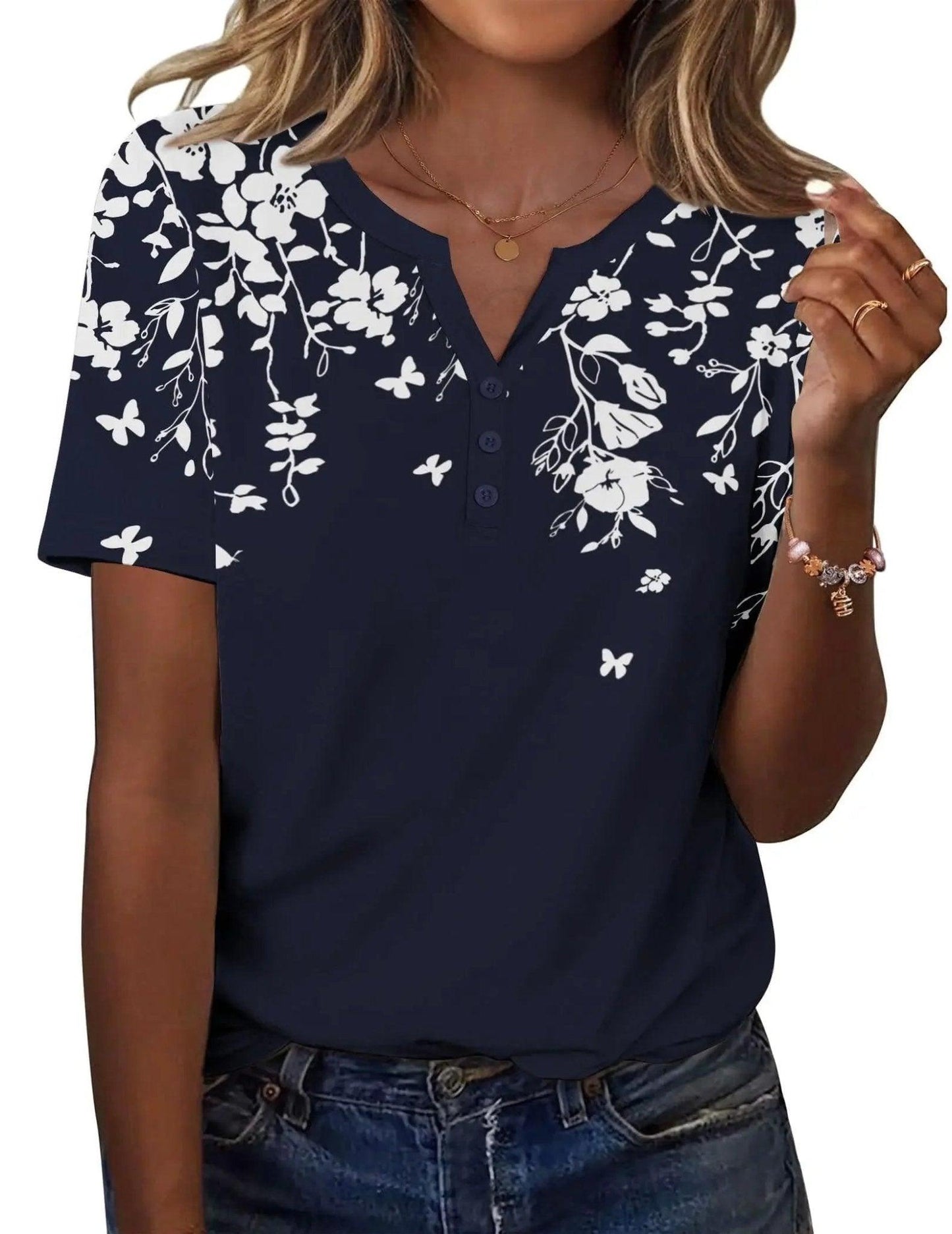 Navy blue floral print women's V-neck button-up top with short sleeves, paired with jeans